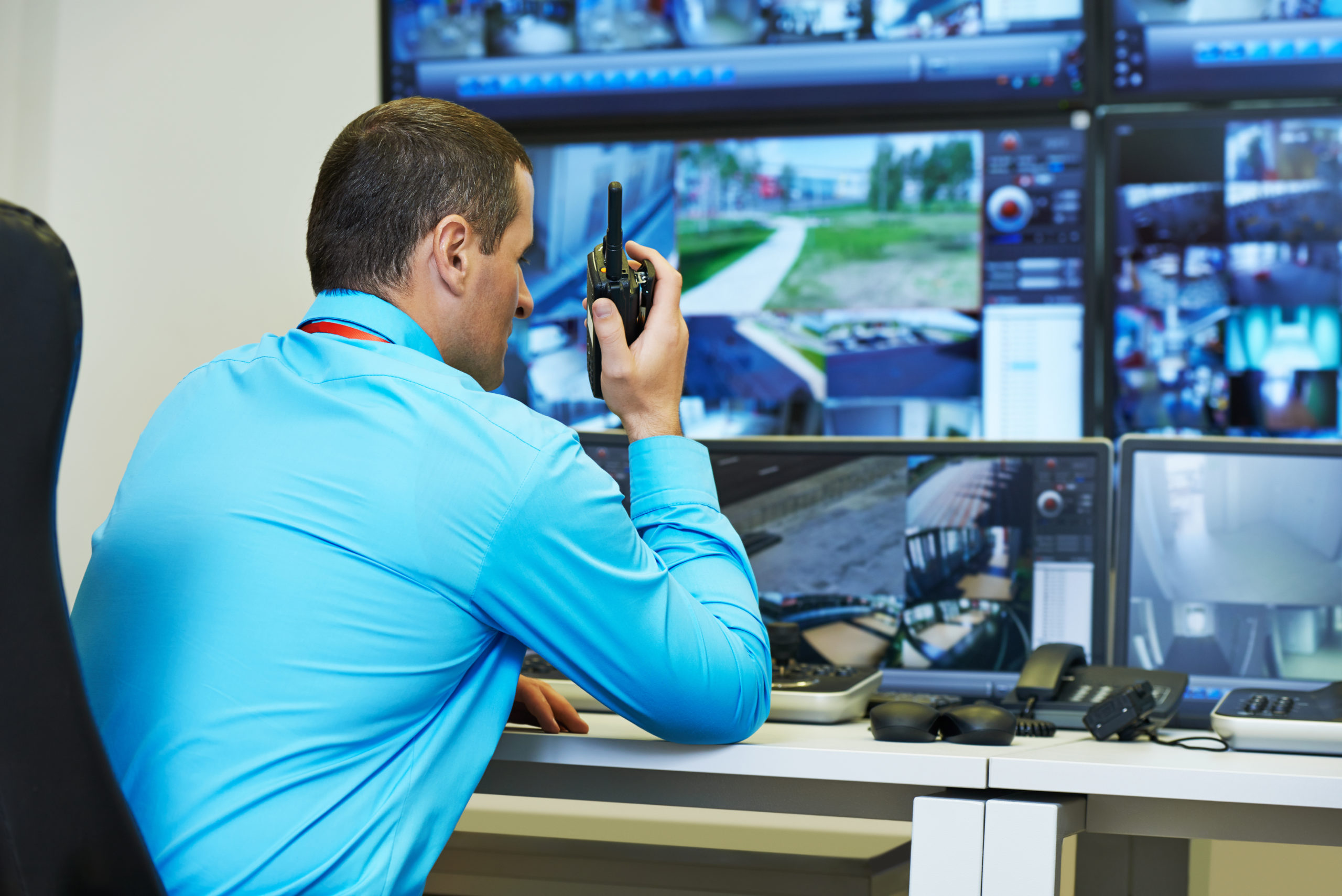 Security guard looking at screens.